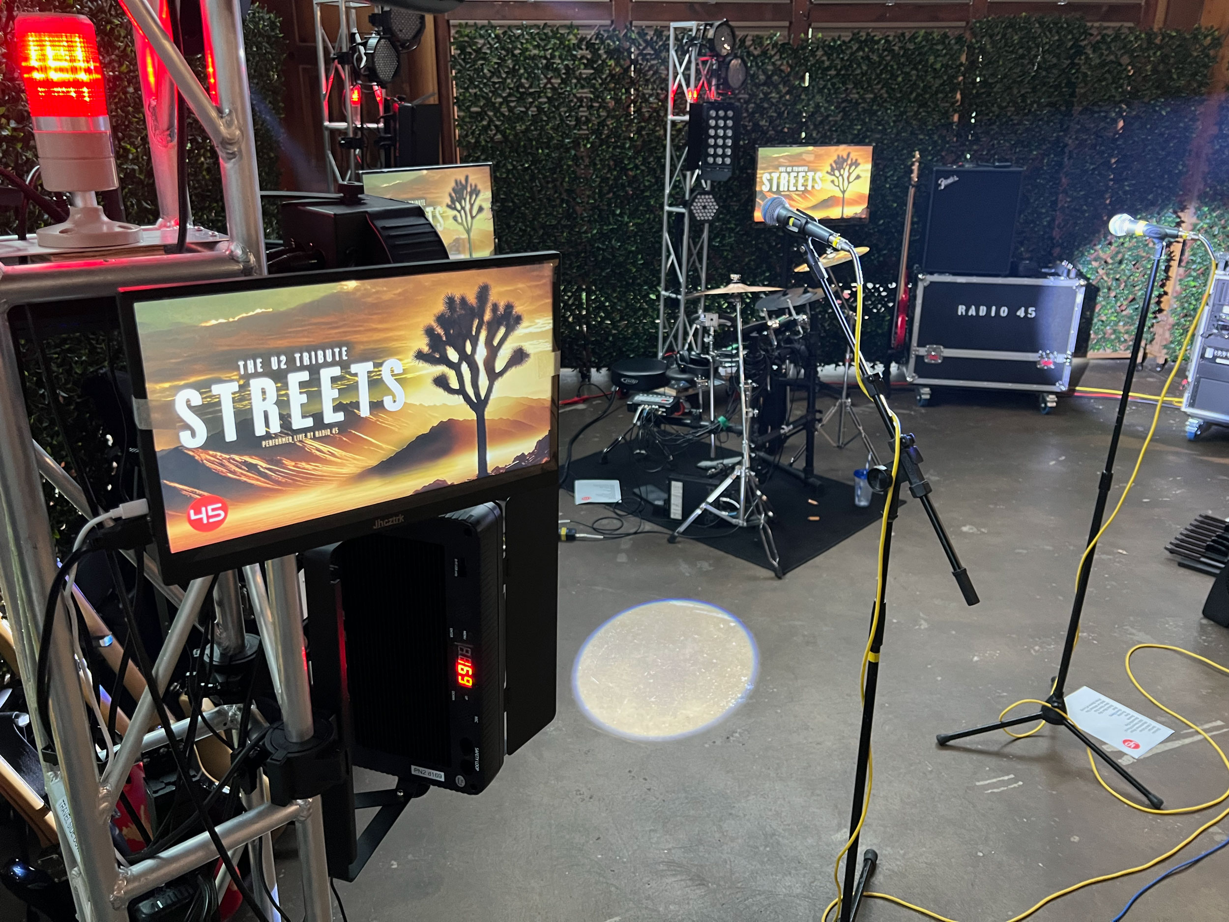 Intimate stage equipped with sound system, instruments and blue lighting